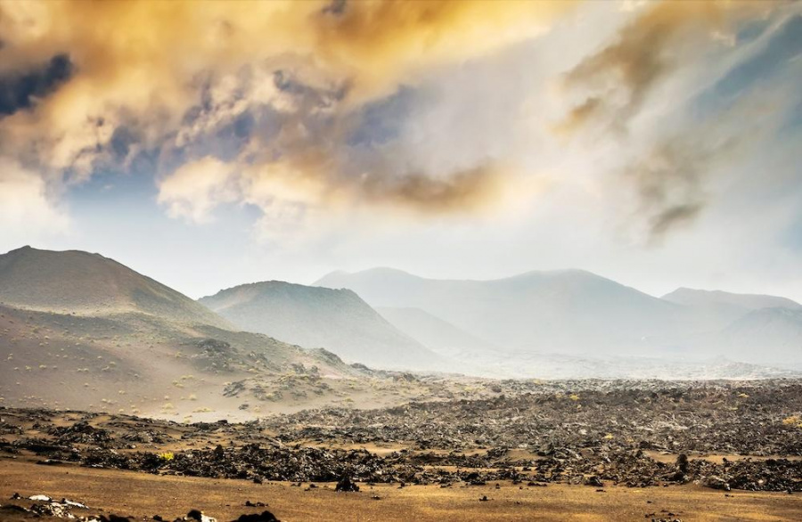 Couple spotted climbing a volcano at The Timanfaya National Park